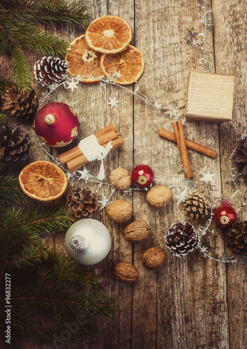 Christmas Decoration. Dried Oranges, Cinnamon Sticks, Walnuts, Baubles, Pine Cones on Old Wooden Background.