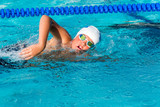 Action shot of teen freestyle swimmer.