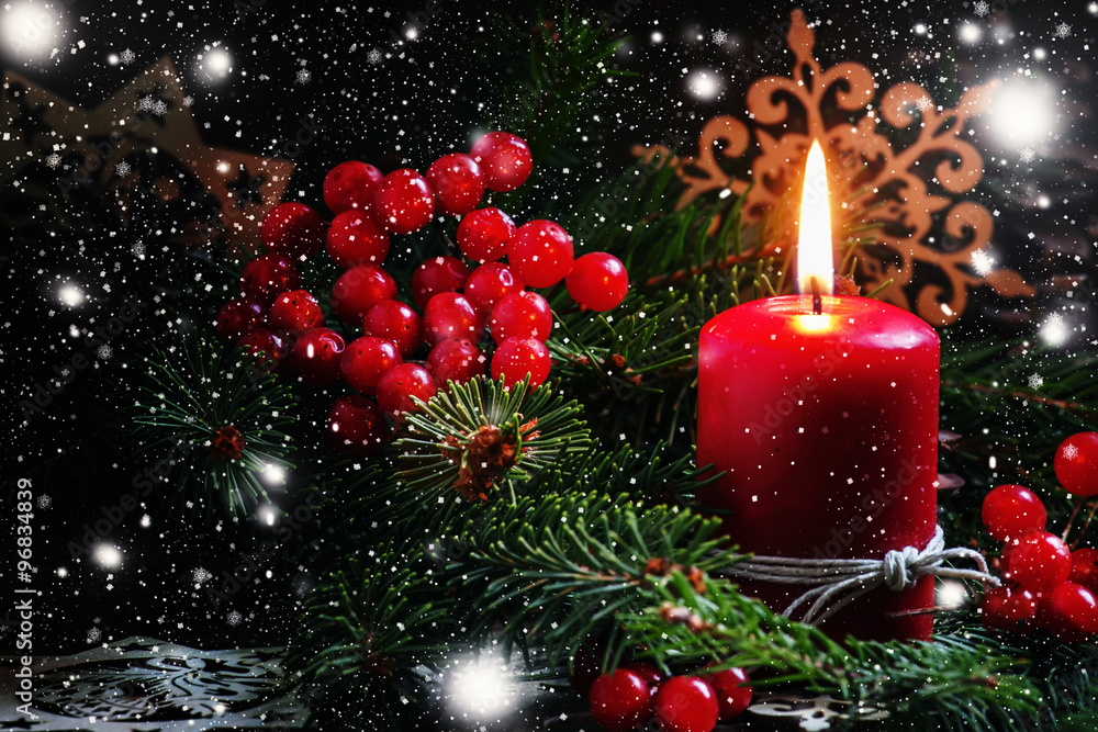 Christmas or New Year's dark composition with burning red candle Christmas or New Year's dark composition with burning red candle