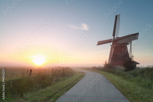 beautiful sunrise behind windmill