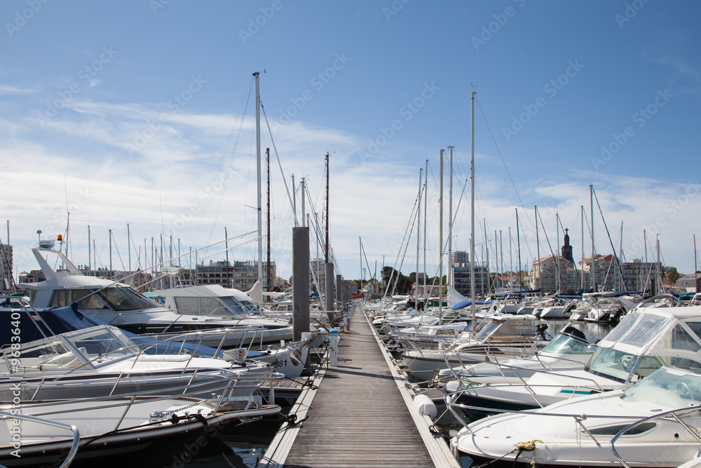 Yachts parking in the beautiful harbour in France against blue sky