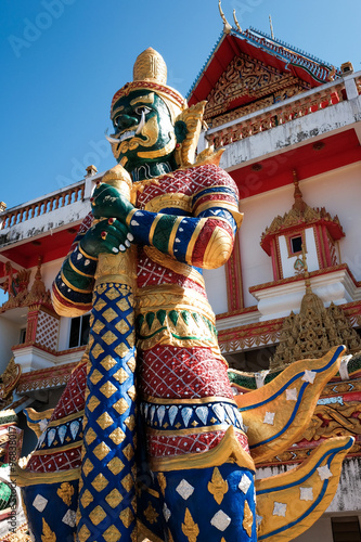 Green giant statue guarding Thai temple (the creation and maintenance was funded by the donation of Thai people, and considered as public property) © Urbanscape