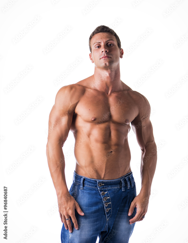 Attractive young man with naked muscular torso, wearing jeans