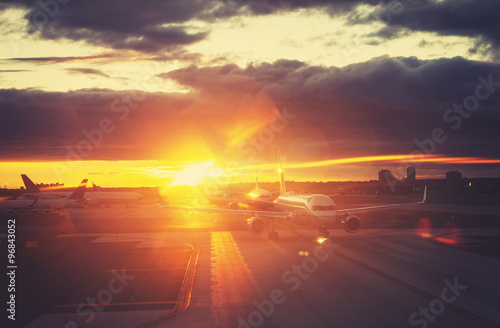 Vintage toned picture of airport at sunset  travel concept.