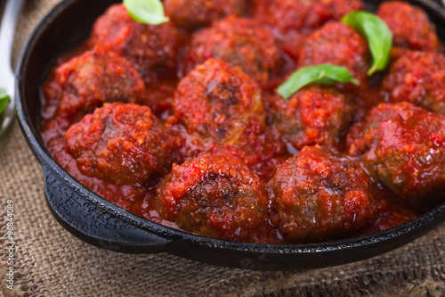 Canvas Print Homemade meatball in frying pan on  rustic wooden table