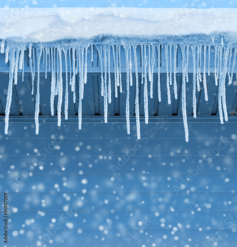 Winter background with icicles covered with hoarfrost