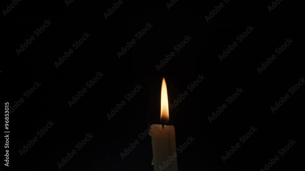 thin candle burning and blown off over dark background thin candle burning and blown off over dark background