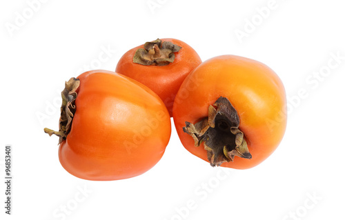 Three persimmons isolated on white photo