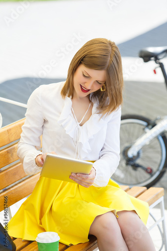 Young woman with tablet pc in the park