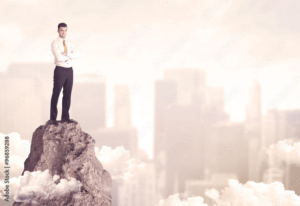 Confident businessman on dangerous cliff Confident businessman on dangerous cliff
