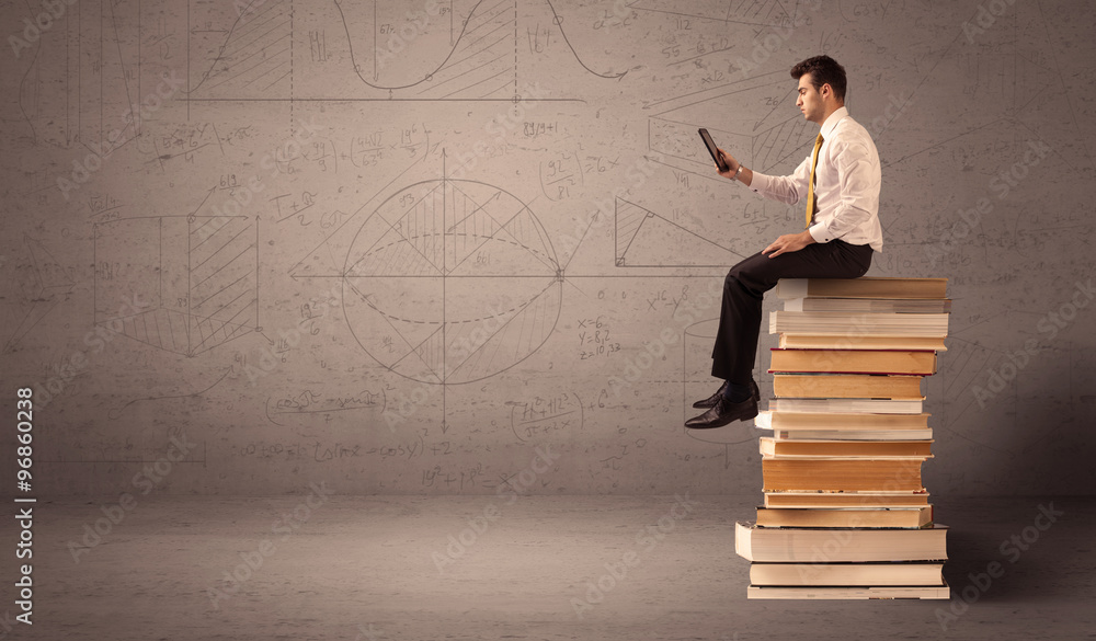 Businessman with tablet sitting on books Businessman with tablet sitting on books