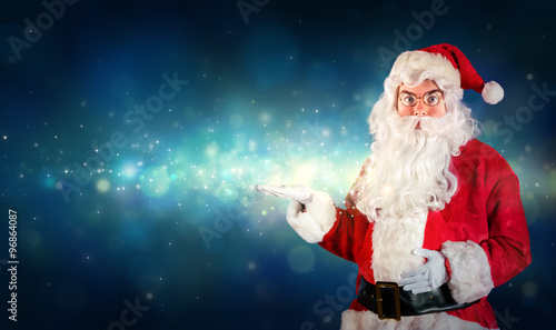 Santa Claus Showing With Hand Something Magical
