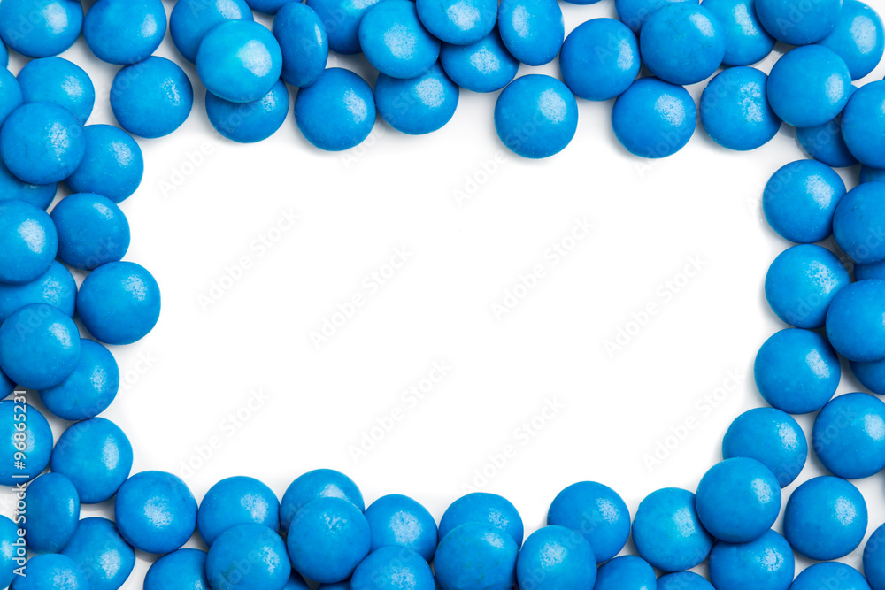 Frame of blue chocolate candy on white background with space Frame of blue chocolate candy on white background with space