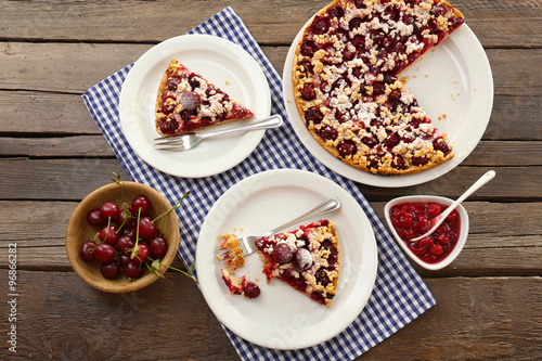 Tasty homemade pie with cherries on table close up