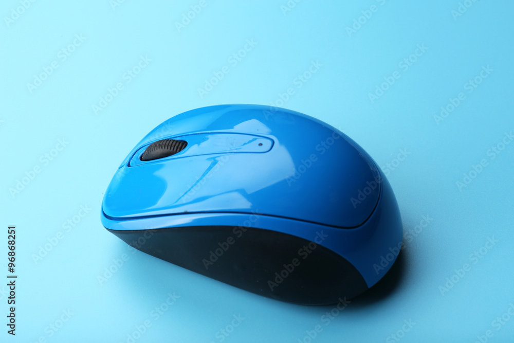 Wireless computer mouse on blue background Wireless computer mouse on blue background