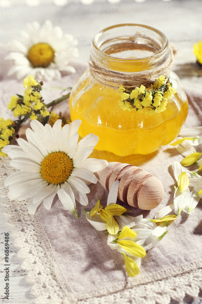 Honey and flowers on napkin closeup Honey and flowers on napkin closeup