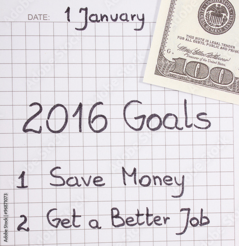 New years resolutions written in notebook and currencies dollar
