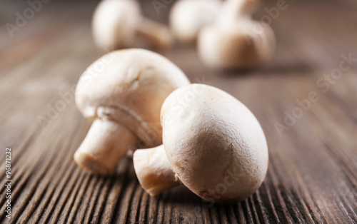 Champignon mushrooms on grey wooden background