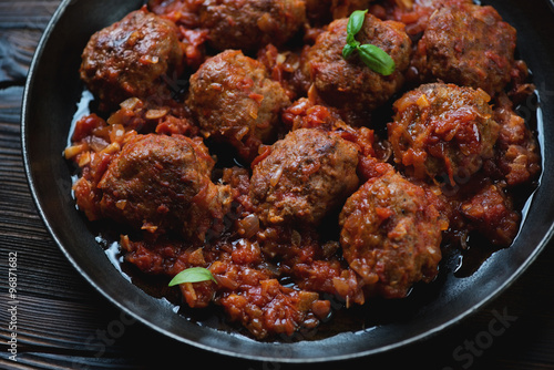 Close-up of meatballs with tomato sauce in a frying pan © Nickola_Che