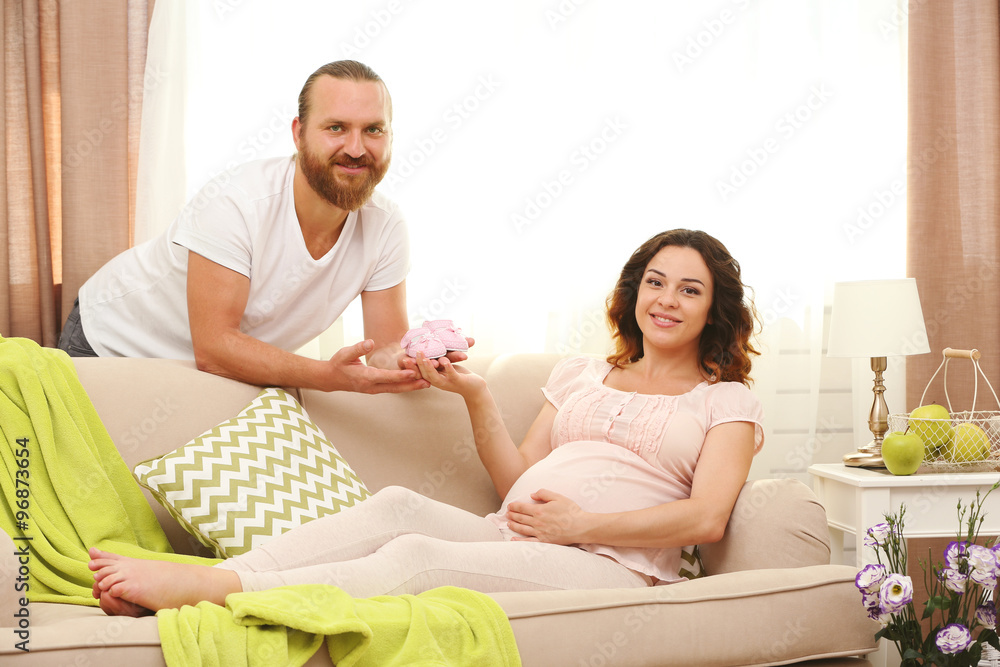 Handsome man and his lovely pregnant woman in the room Handsome man and his lovely pregnant woman in the room