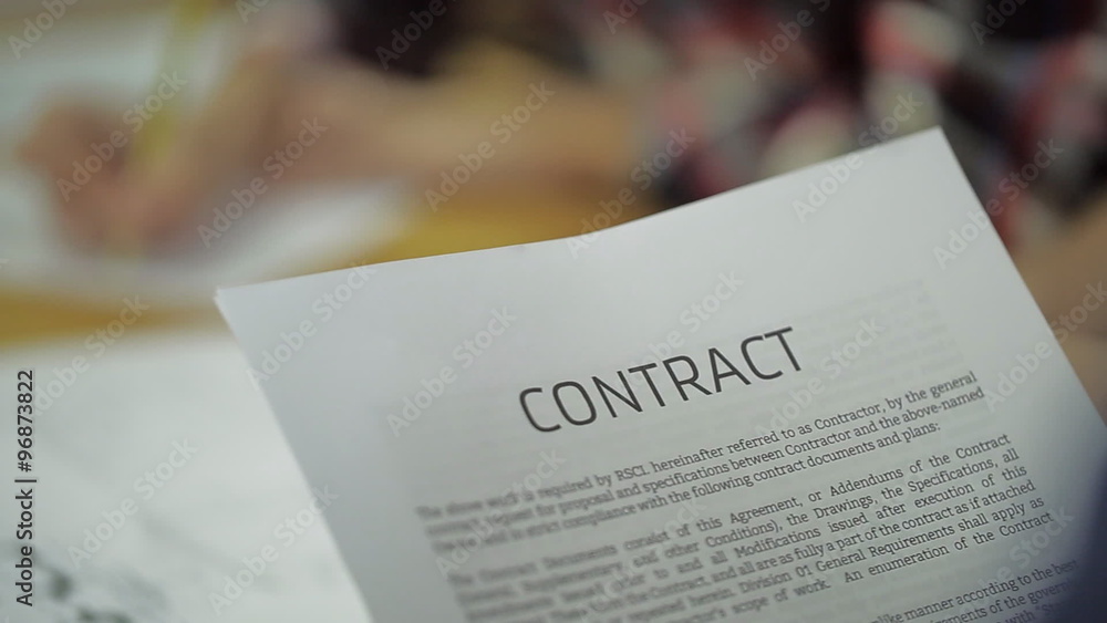 read Business Contract, Mutual Agreement, in blurring the background is the same Signing read Business Contract, Mutual Agreement, in blurring the background is the same Signing