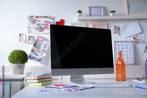 Modern workplace with computer on the table in decorated room