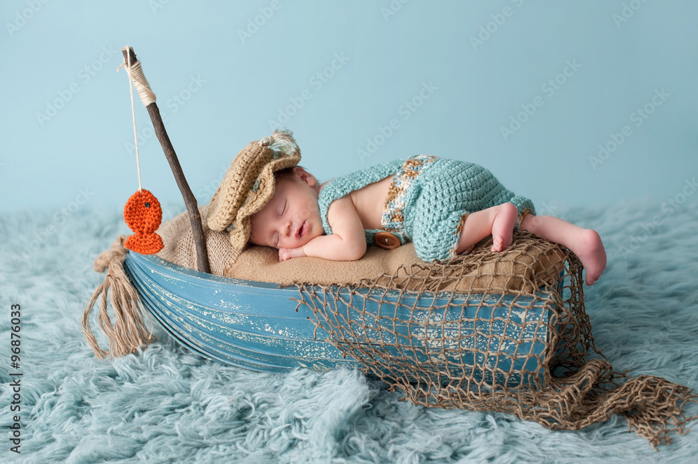 Newborn Baby Boy in Fisherman Outfit Stock Photo