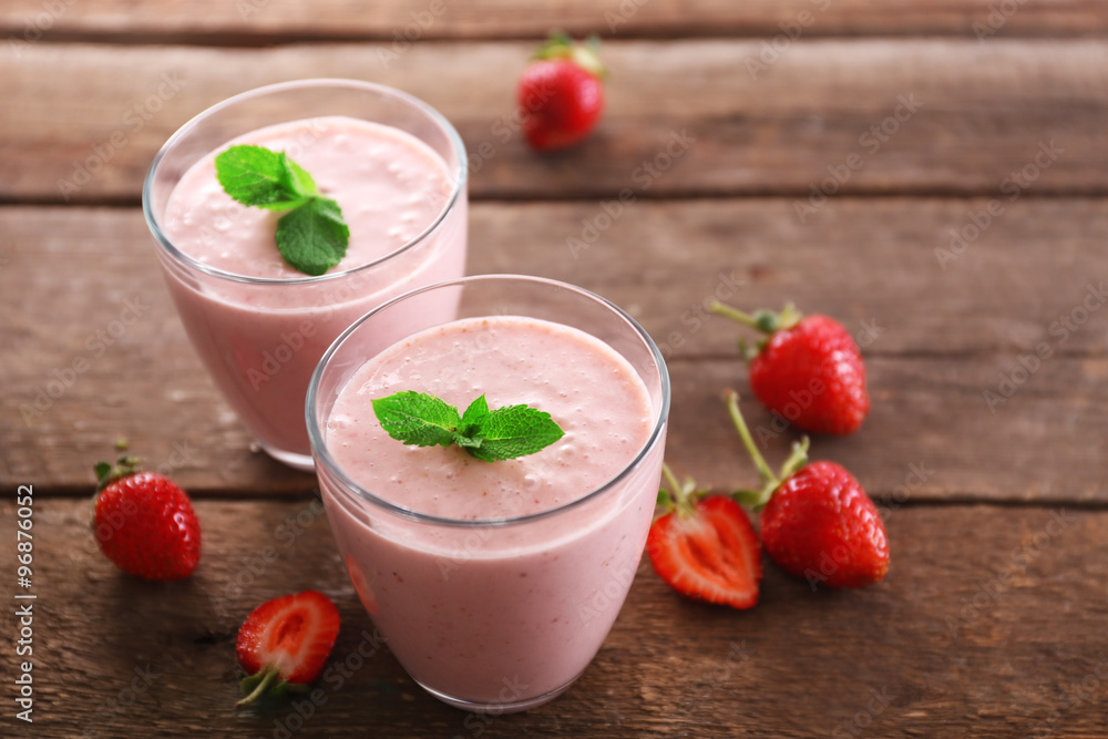 Fresh strawberry yogurt with berries around on wooden background Fresh strawberry yogurt with berries around on wooden background