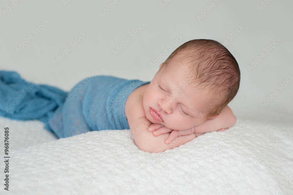 Sleeping Newborn Baby Boy Swaddled in Blue Sleeping Newborn Baby Boy Swaddled in Blue