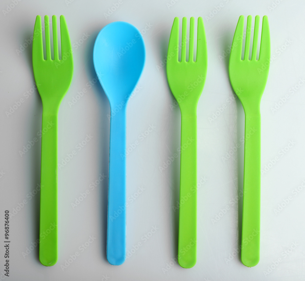 Disposable colourful forks and spoon, isolated on white, top view, Individuality concept Disposable colourful forks and spoon, isolated on white, top view, Individuality concept