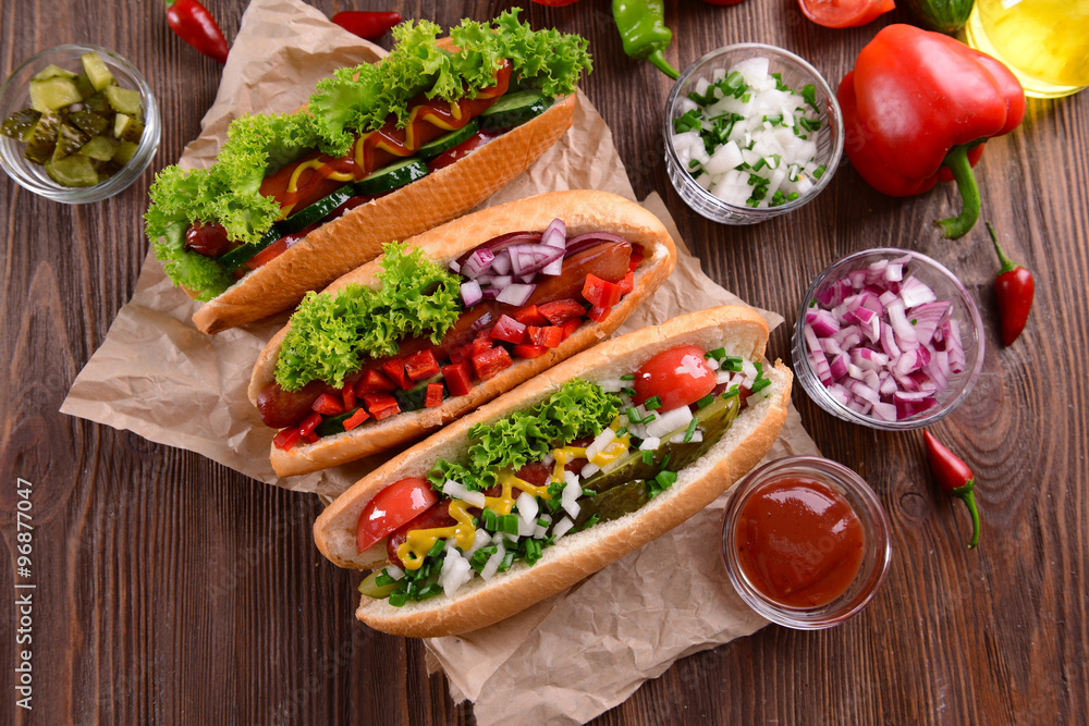 Hot dogs and vegetables on craft paper closeup Hot dogs and vegetables on craft paper closeup