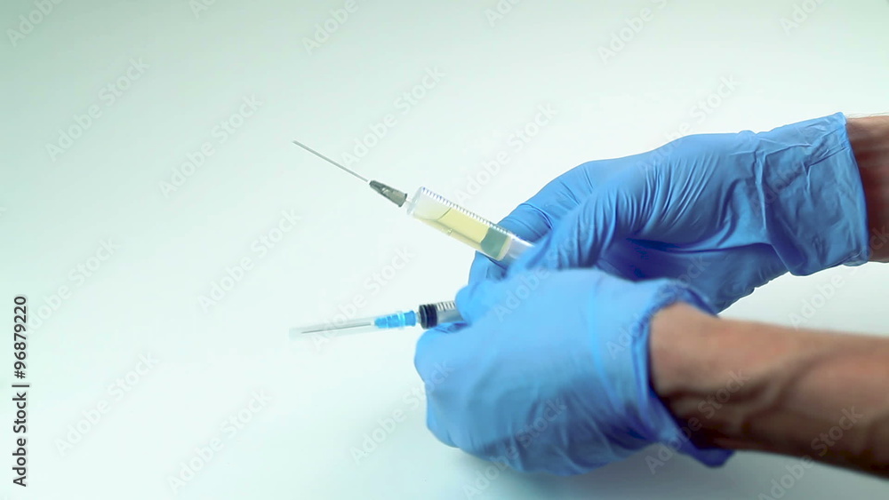 Doctor Gains a Medicine Into a Syringe Doctor Gains a Medicine Into a Syringe