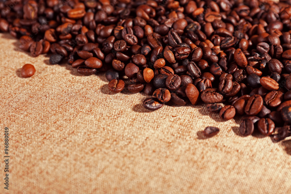 Roasted coffee beans on the linen fabric Roasted coffee beans on the linen fabric