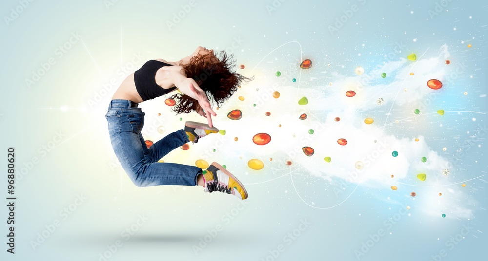 Beautiful woman jumping with colorful gems and crystals on the b Beautiful woman jumping with colorful gems and crystals on the b