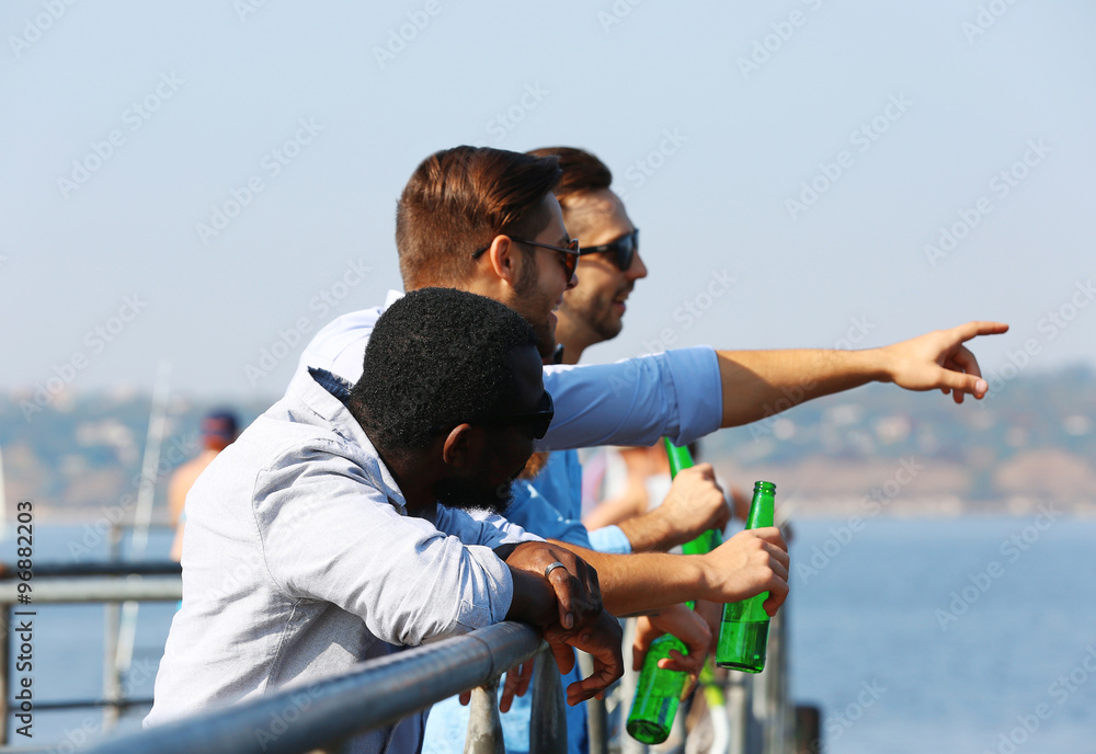 Young men talking on the riverside Young men talking on the riverside