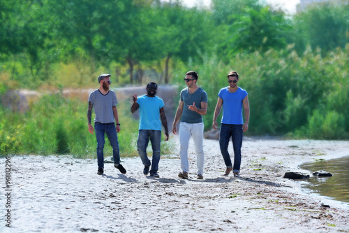 Young men walking along the...