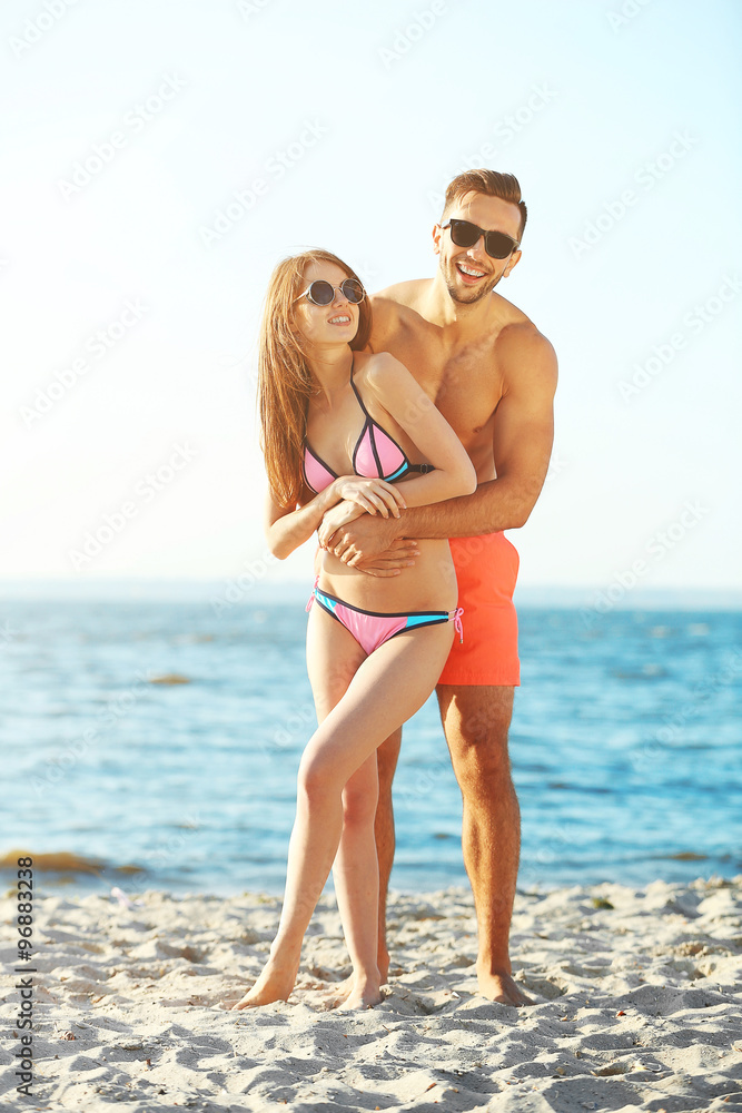 A guy hugging a girl at the beach, outdoors A guy hugging a girl at the beach, outdoors