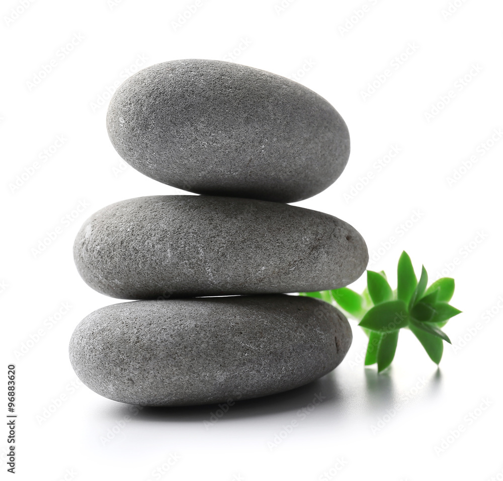 Stack of stones and a green flower, isolated on white. Spa relaxation concept Stack of stones and a green flower, isolated on white. Spa relaxation concept