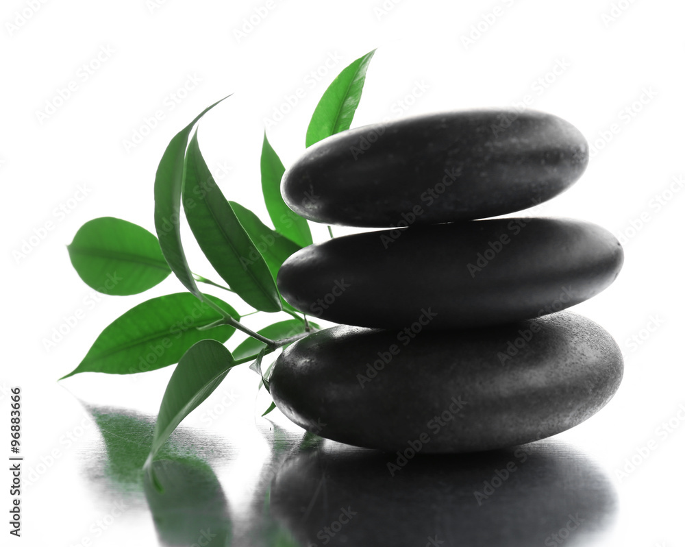 Stack of stones and a green flower, isolated on white. Spa relaxation concept Stack of stones and a green flower, isolated on white. Spa relaxation concept