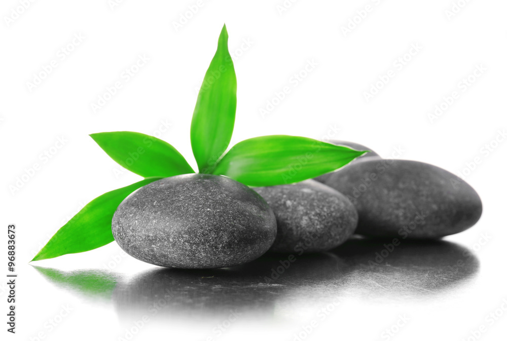 Stack of stones and a green flower, isolated on white. Spa relaxation concept Stack of stones and a green flower, isolated on white. Spa relaxation concept