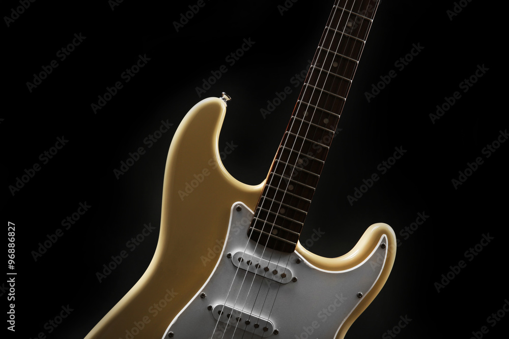 Obraz premium Part of white electric guitar, on black background
