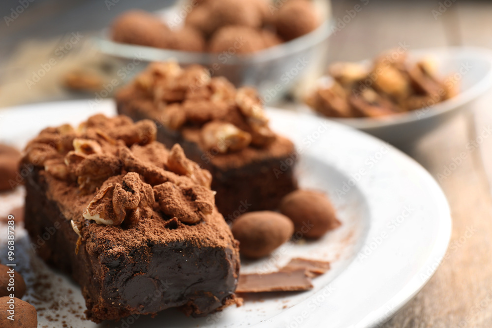 Pieces of chocolate cake with walnut on the table, close-up Pieces of chocolate cake with walnut on the table, close-up