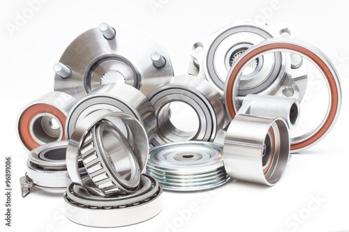 located on a white background variety of bearings and rollers wide range of applications, from automotive hub to engine belt tensioners