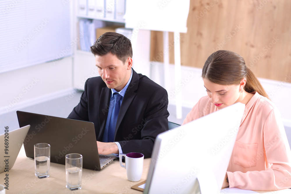 Business meeting - manager discussing work with his colleagues Business meeting - manager discussing work with his colleagues