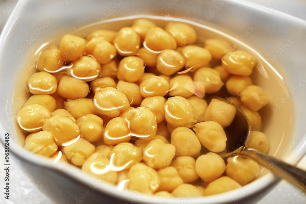 Canned corn and juice in a white bowl, on the table, close-up Canned corn and juice in a white bowl, on the table, close-up