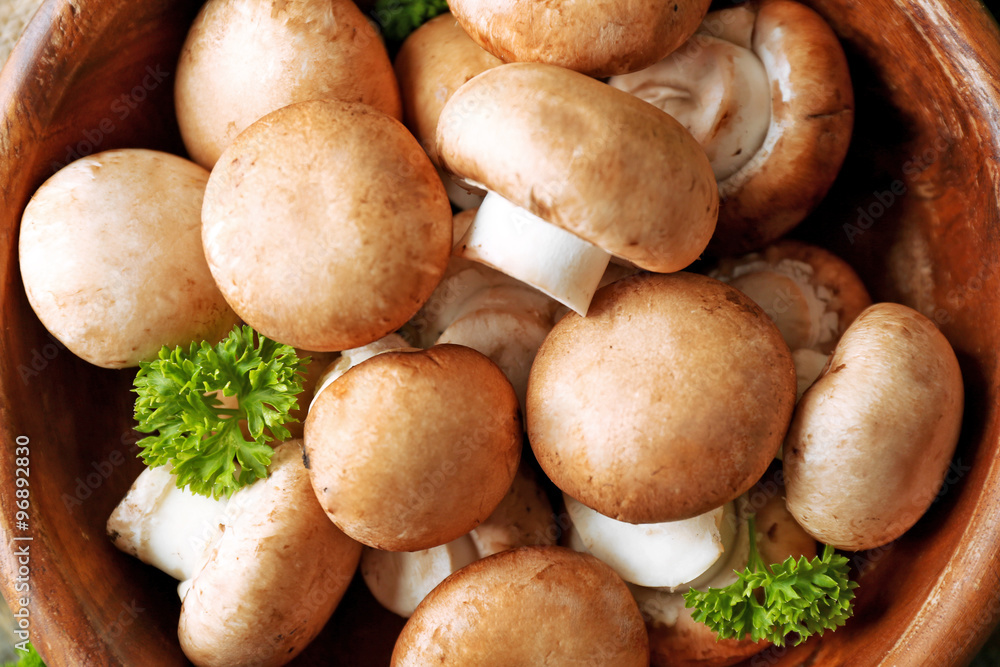 Mushrooms in wooden bowl, close-up Mushrooms in wooden bowl, close-up
