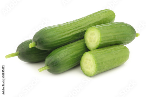 fresh green snack cucumbers on a white background