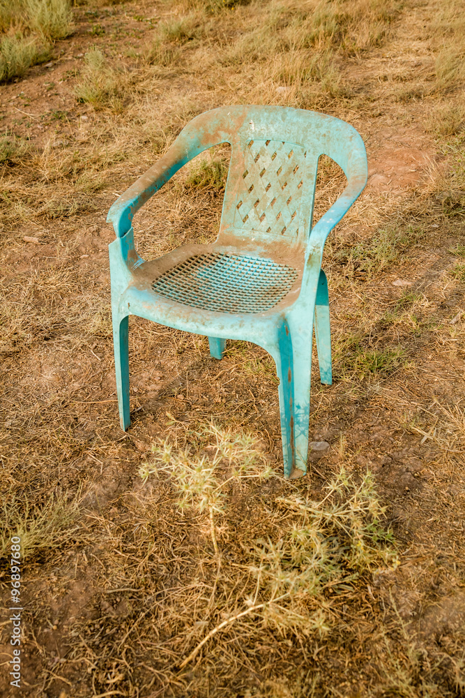 Grungy Retro Damaged Plastic Green Chair Abandoned in a Field Grungy Retro Damaged Plastic Green Chair Abandoned in a Field