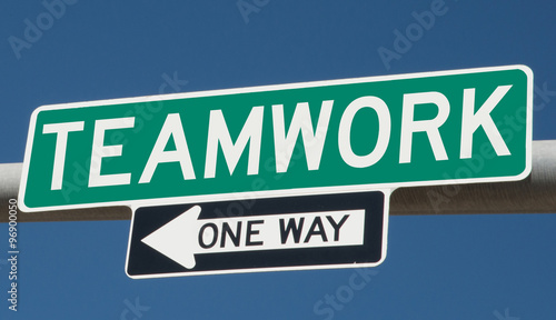 Teamwork printed on green overhead highway sign with one way arrow  © Rex Wholster