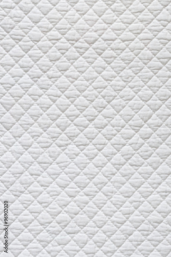 Closeup of white quilted fabric